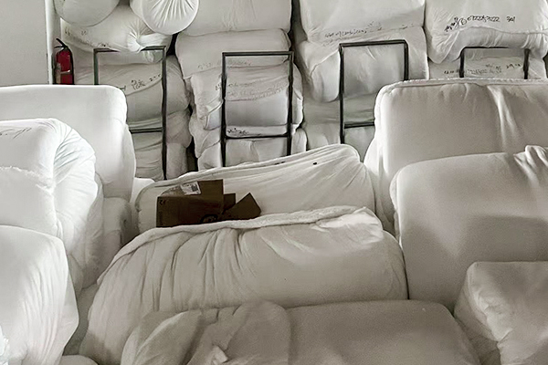Warehouse with finished fabric rolls prepared for global shipment from lanfex textile factory