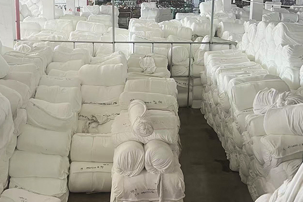 Stacked fabric rolls organized in the lanfex warehouse for efficient apparel textile distribution